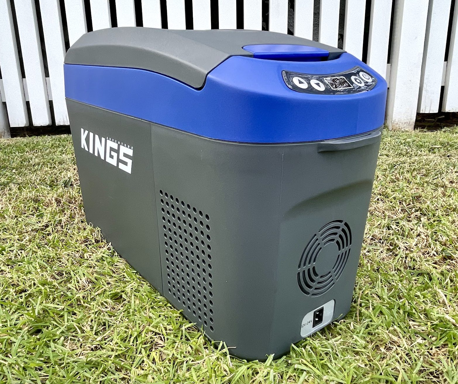 Kings 12V console fridge in grass with lid closed