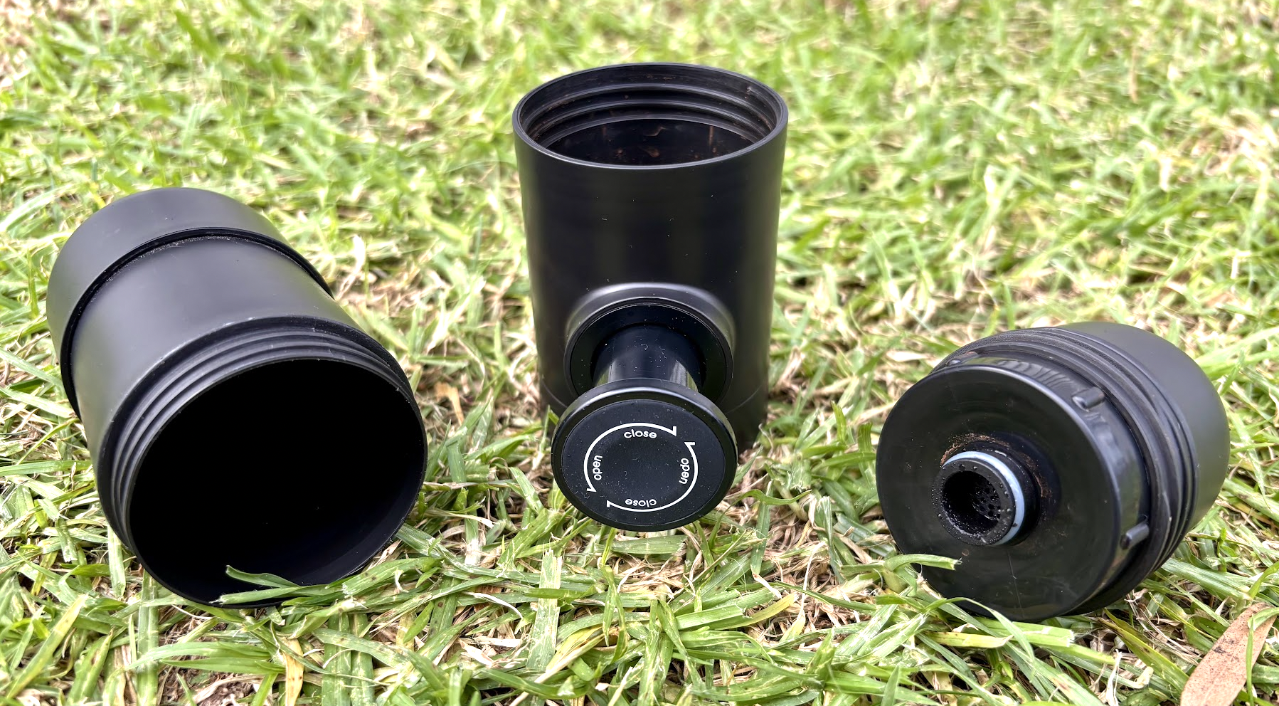 Unassembled portable espresso machine to prepare for a fresh camp brew