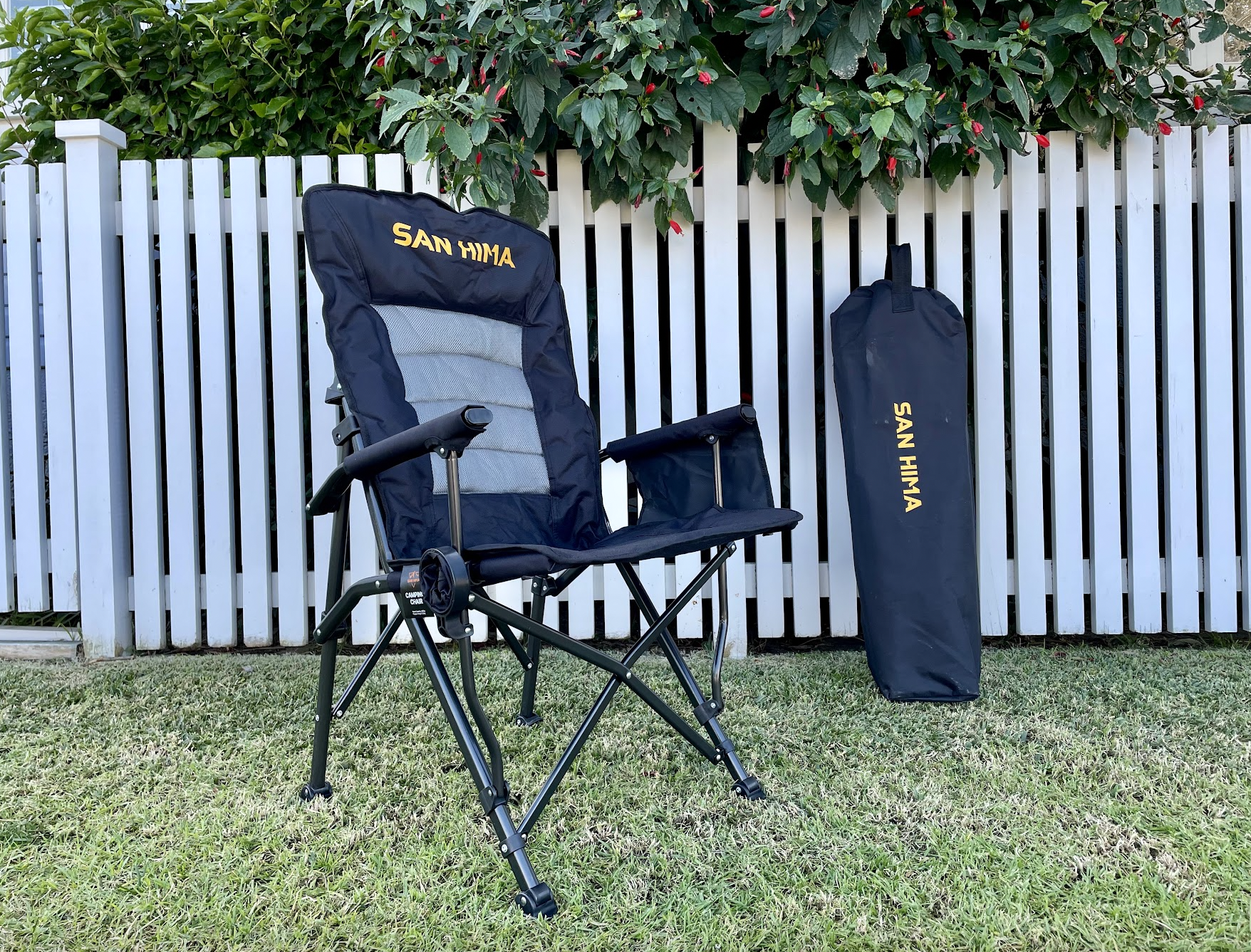 The San Hima recliner camping chair​ next to carry bag