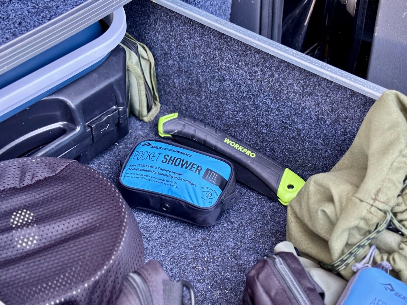 Sea to Summit pocket shower and Workpro folding saw packed away in Titan drawer