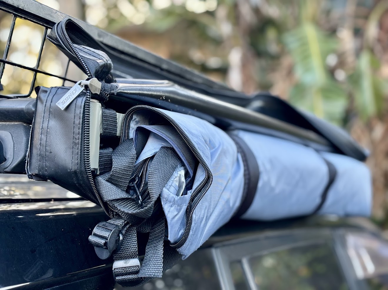 Uzipped Kings Shower Tent mounted to roof basket