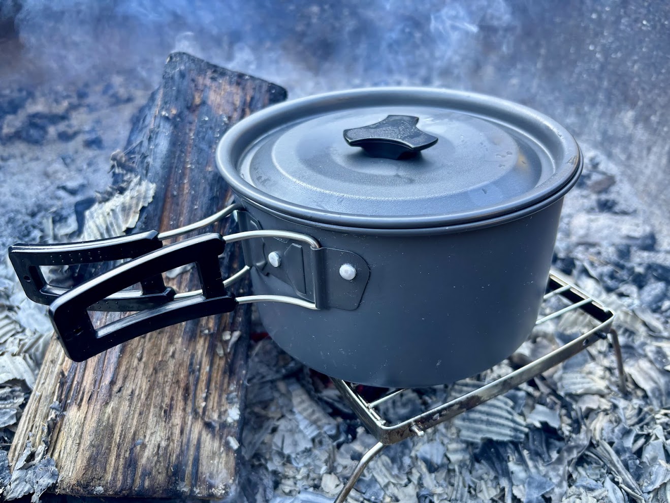 Aluminum camp pot with lid over camp fire using my portable grill