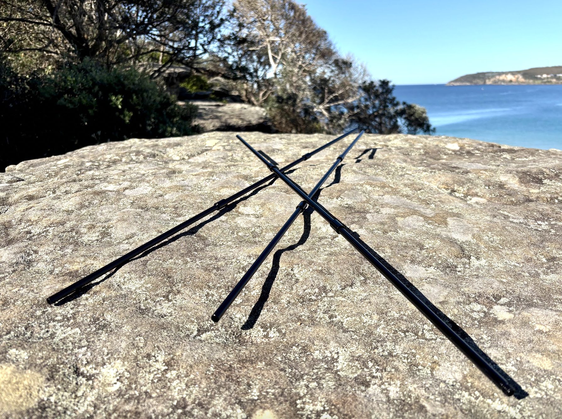 Assembled black aluminium legs of camp fire tripod