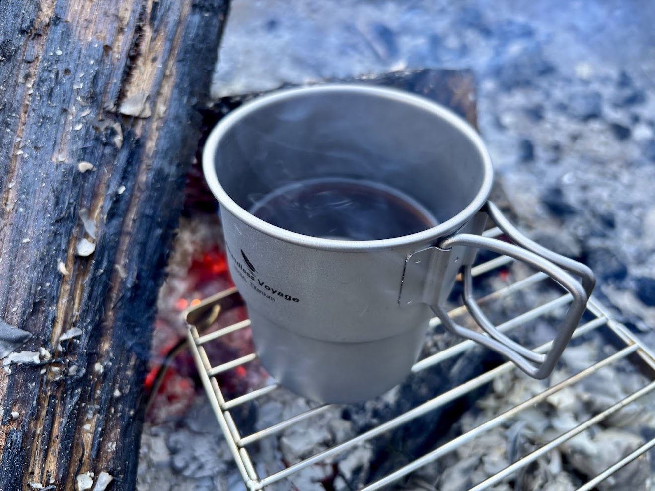 Brewing camp coffee in Boundless Voyage titanium mug 250ml over the camp fire