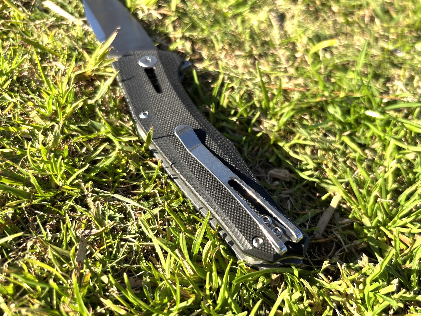 Deep-carry pocket clip on the grip of this G10 folding knife