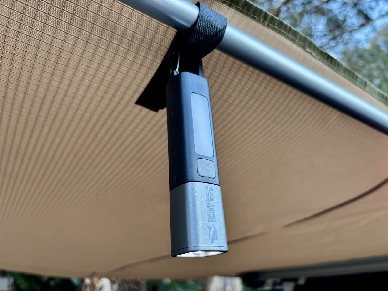 Hanging the Smiling Shark camping torch from our XTM awning using the build-in hook