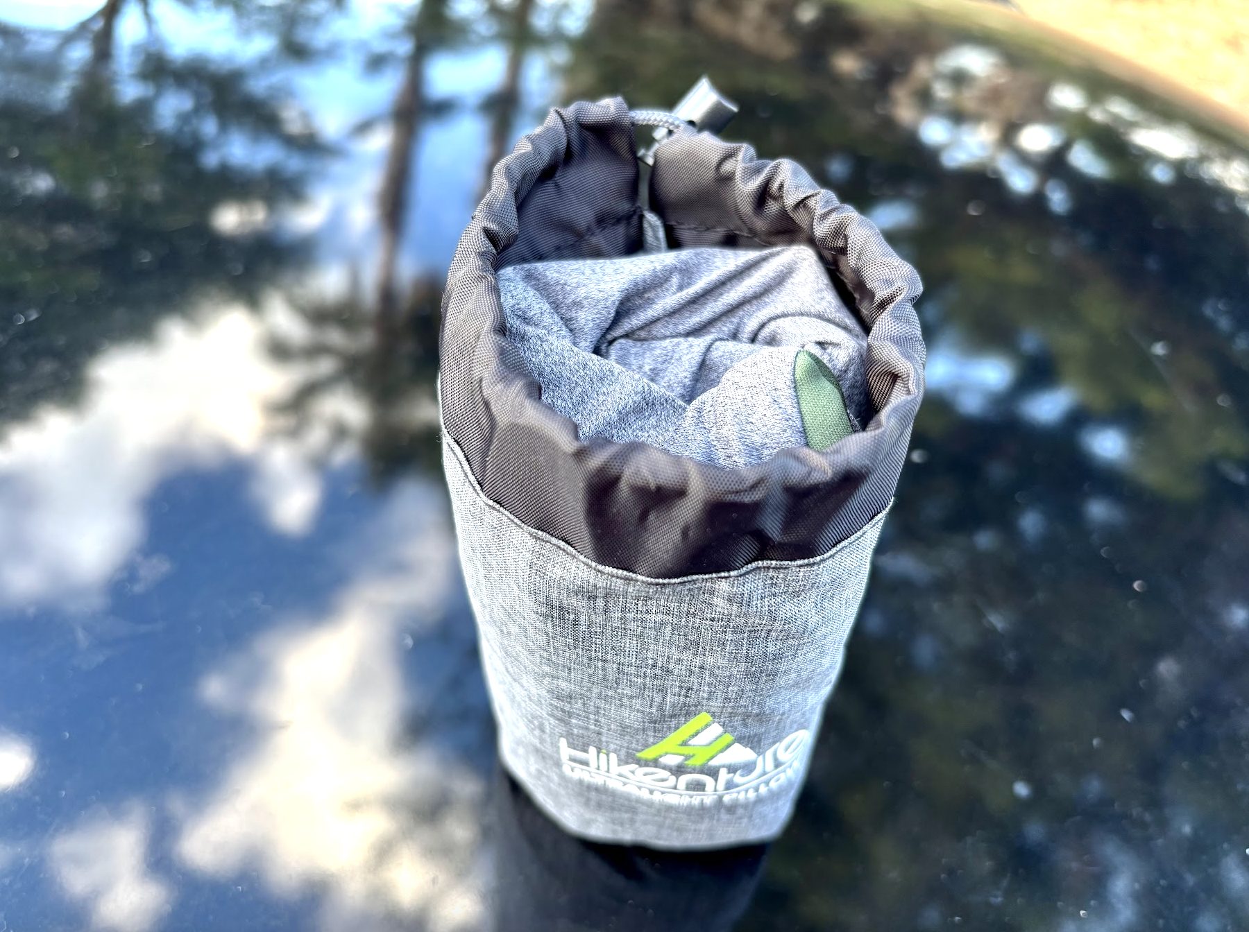 Rolled up Hikenture inflatable pillow inside of storage pouch