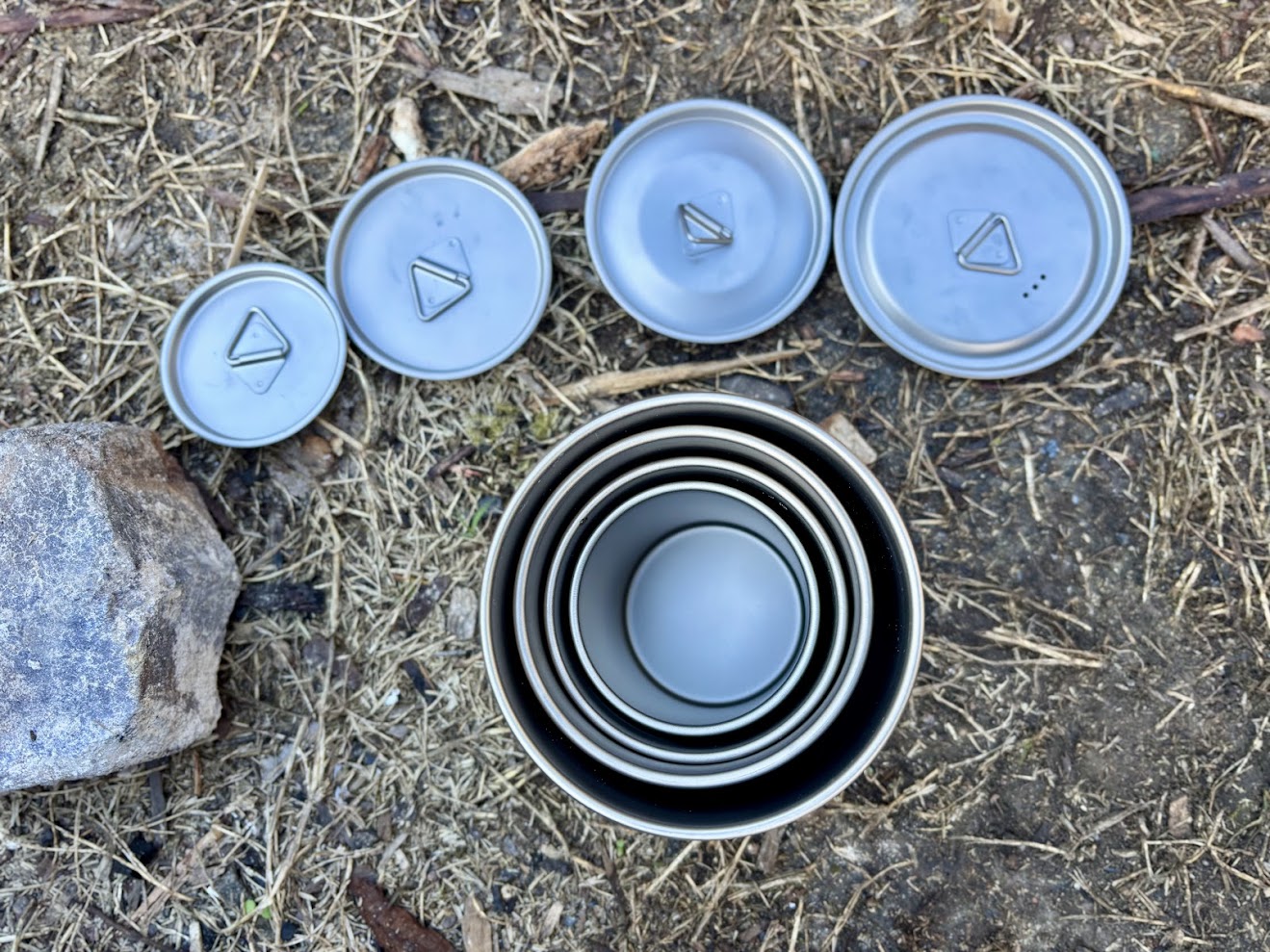 Nestable sizes of the Ti Artisan titanium cup for camping (200ml, 300ml, 450ml, 750ml)
