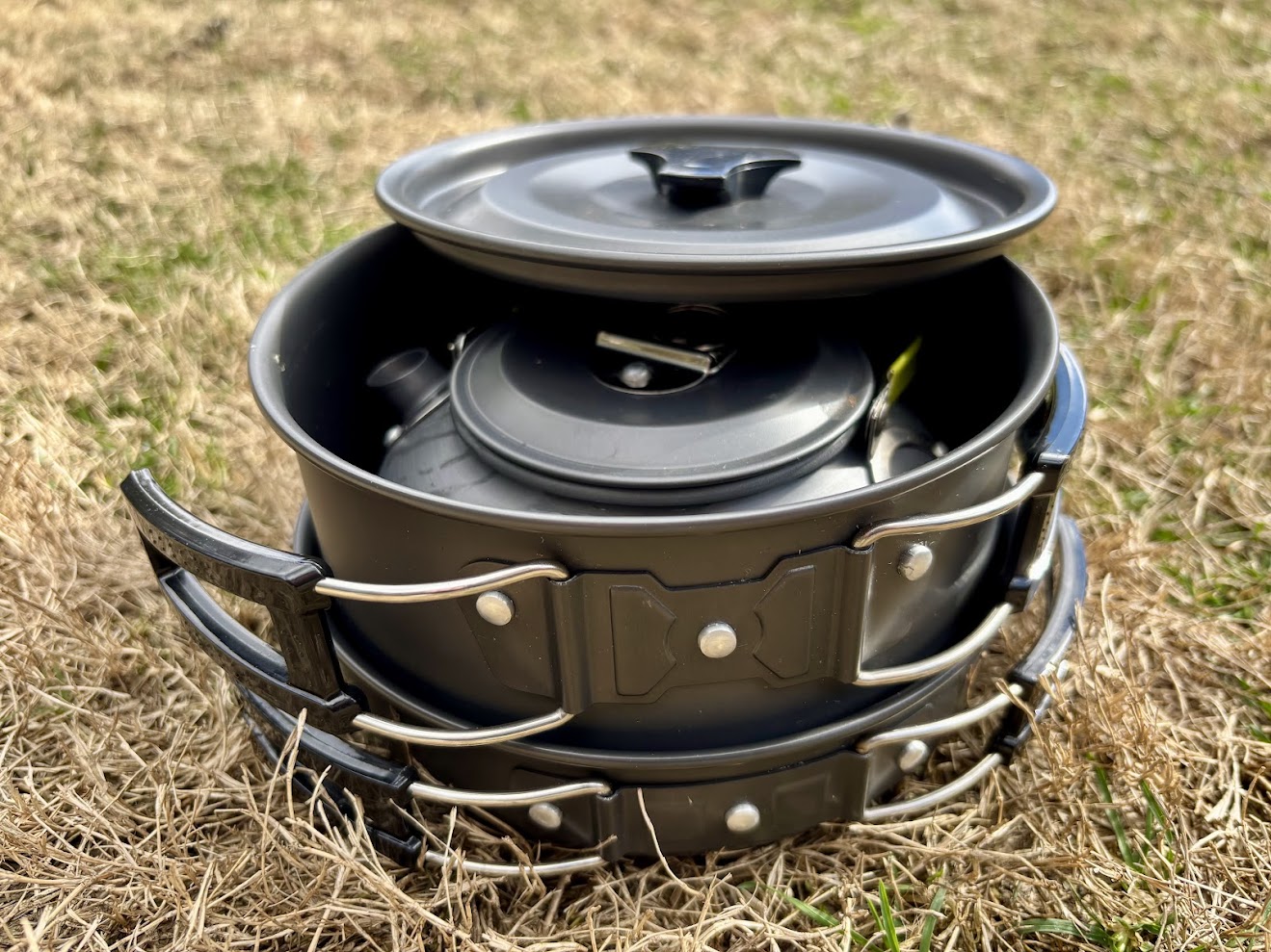 Nesting design of this compact camping cookware set with the kettle nested inside a pot, which is then nested inside the frying pan.