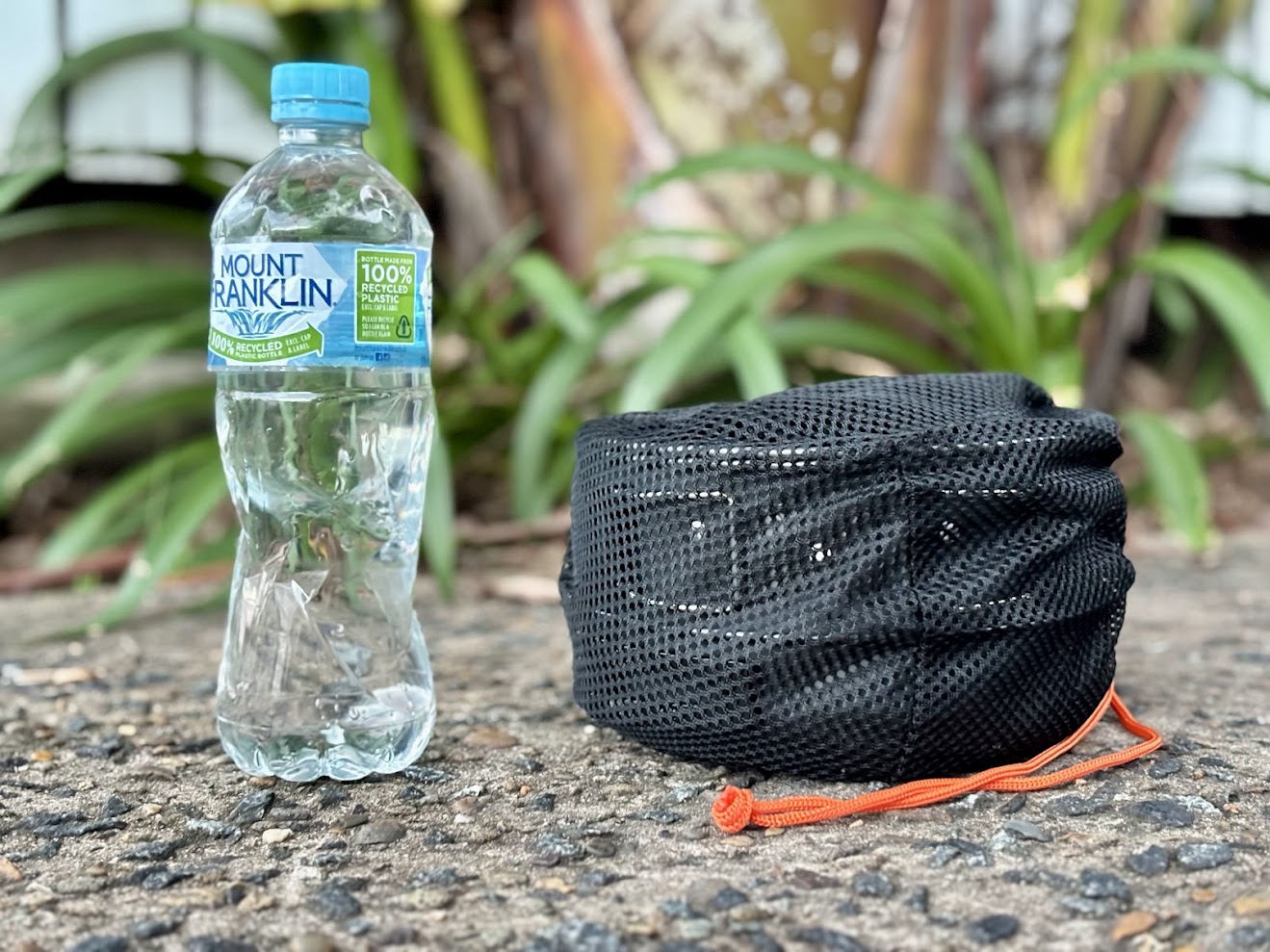 Packed away the size of this camping cookware set is 16x10cm, shown next to 600ml water bottle