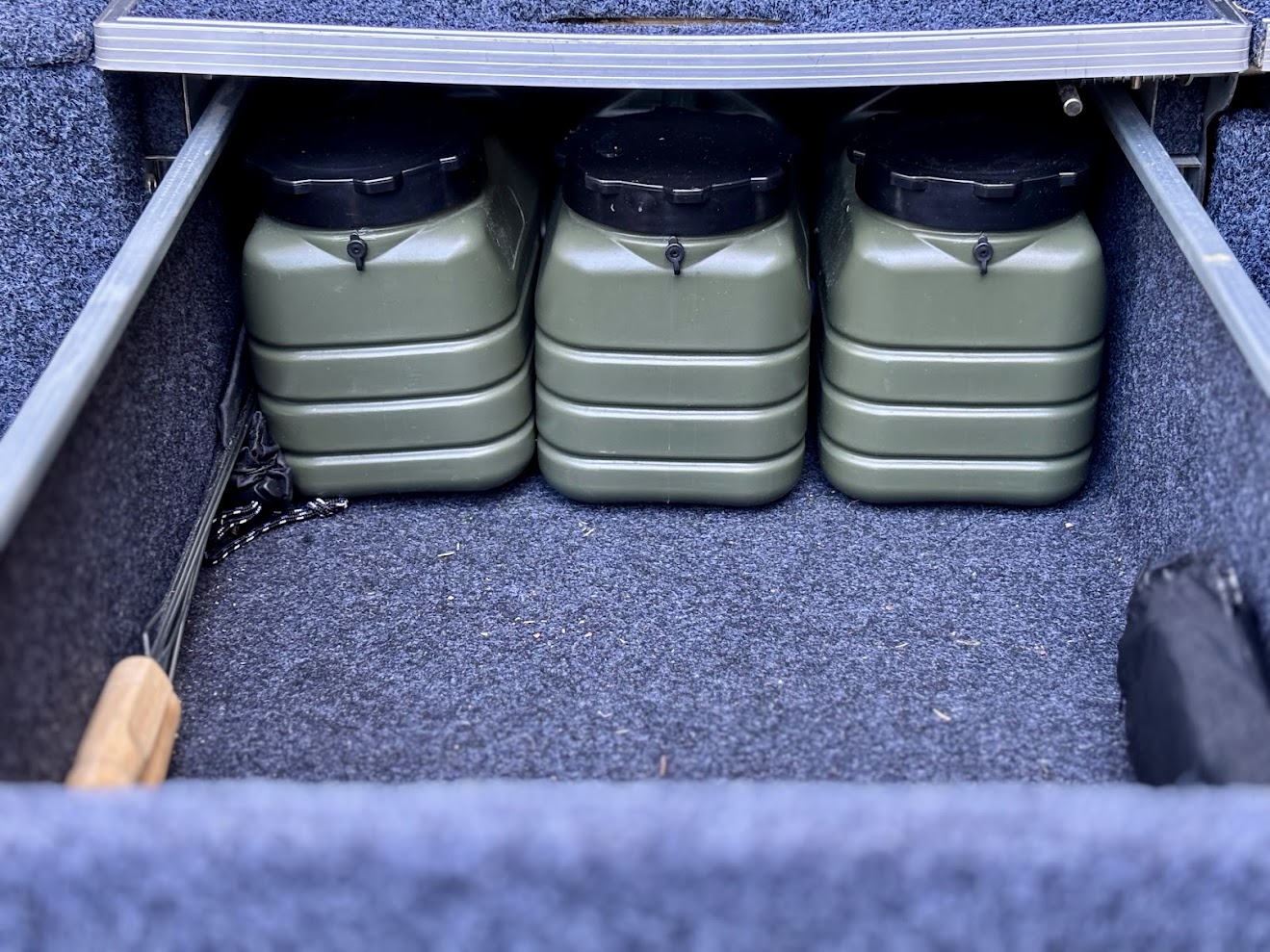 Three 5L water containers stored in the back of my Titan drawer system
