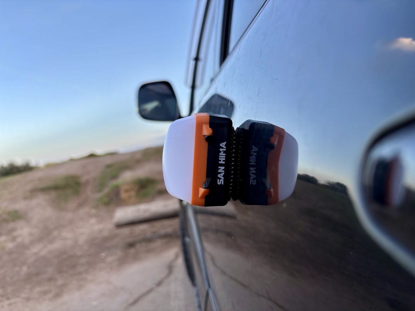 Using the magentic base to stick the San Hima magnetic camping light to the car