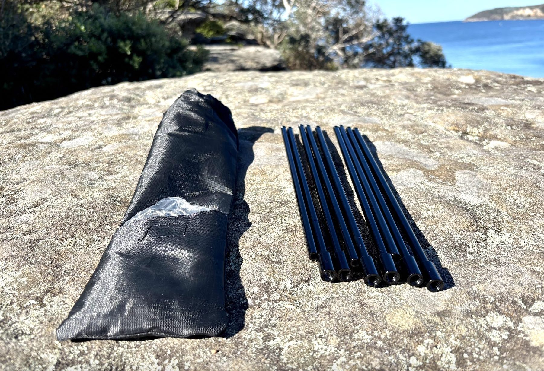 Unpacking screwable legs of lightweight tripod for camp fire cooking