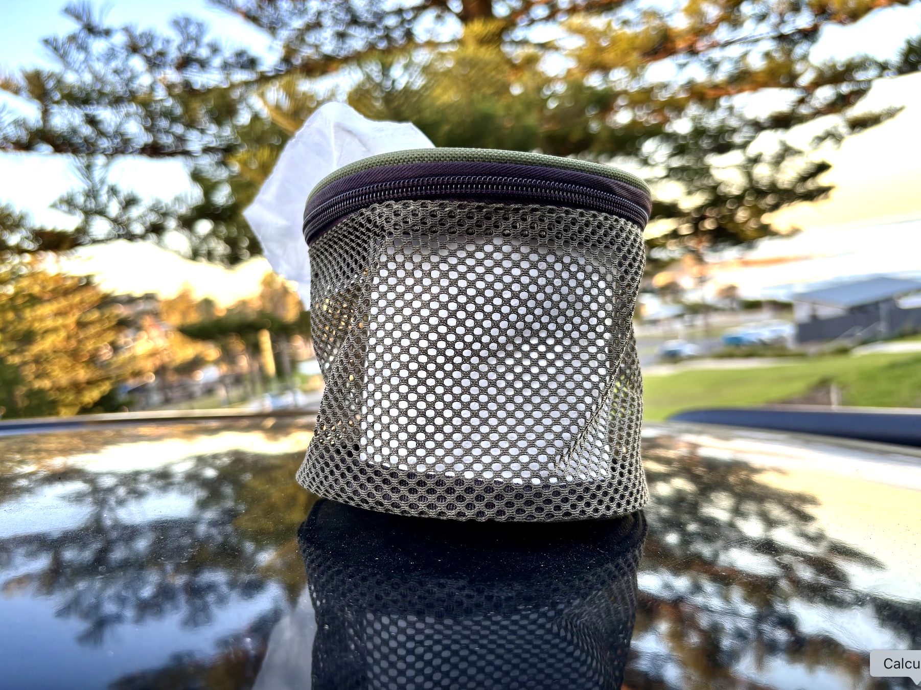 Fitting a standard toilet paper roll in portable mesh camp toilet paper holder