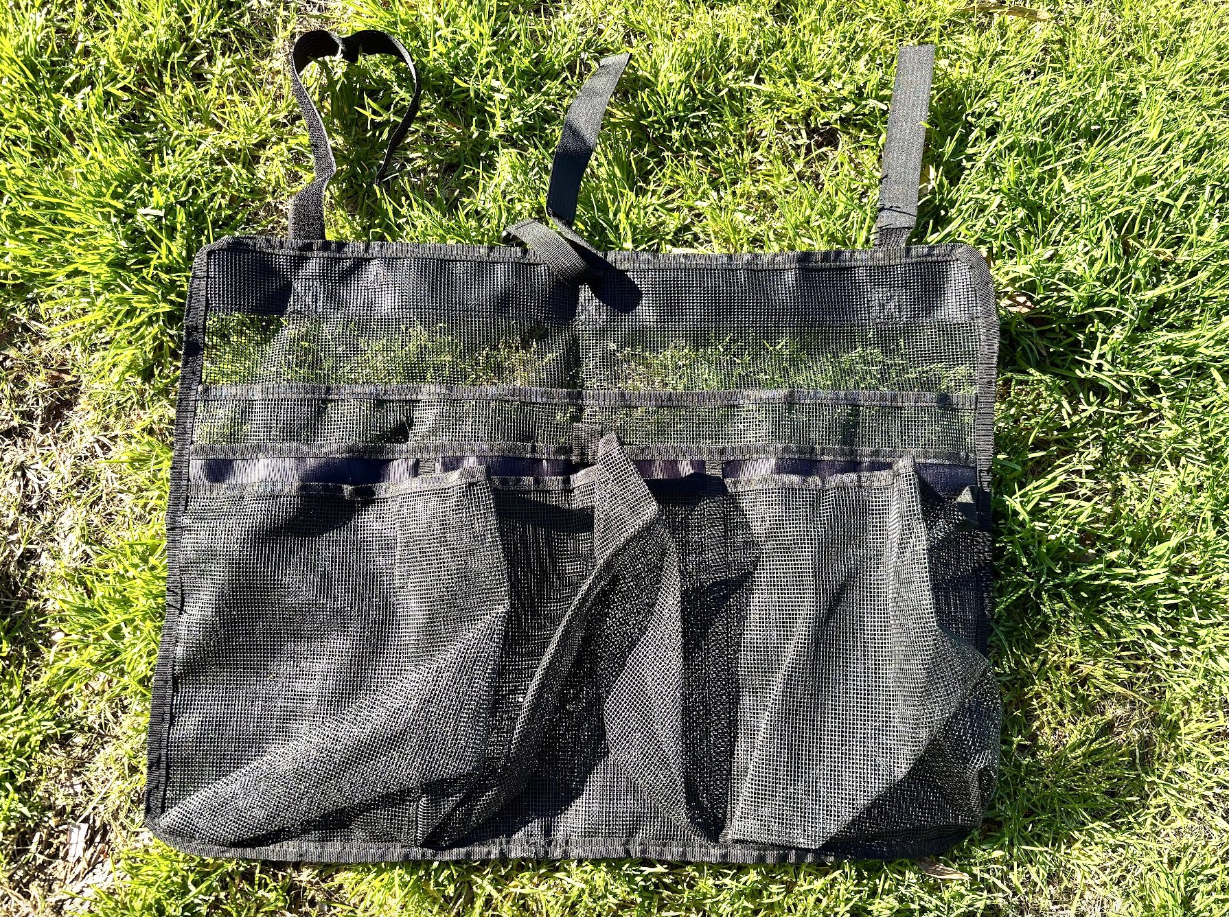 Top view of collapsible camping kitchen organizer in grass