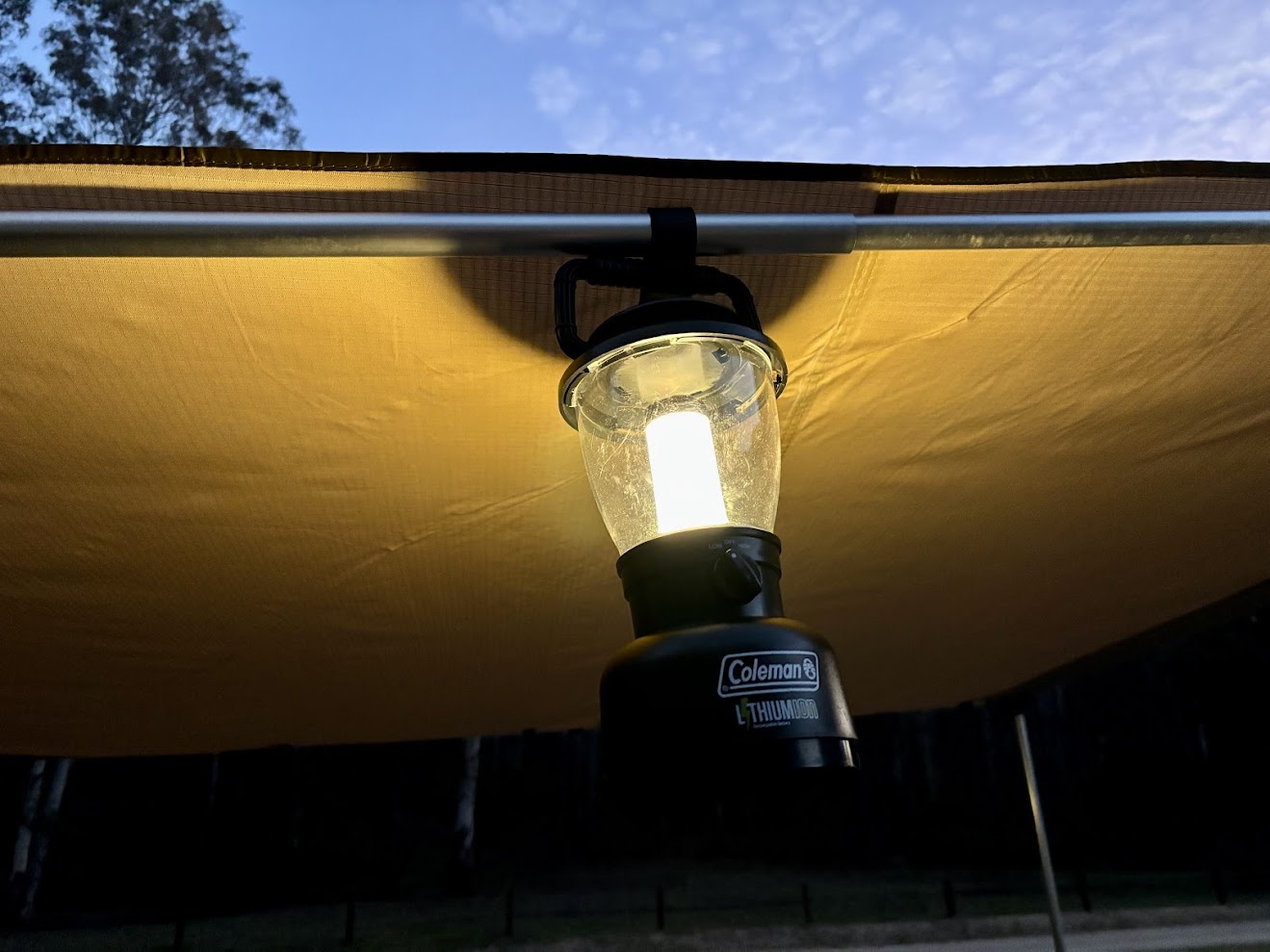Coleman rechargeable lantern hanging from aqning at Coorongooba campground