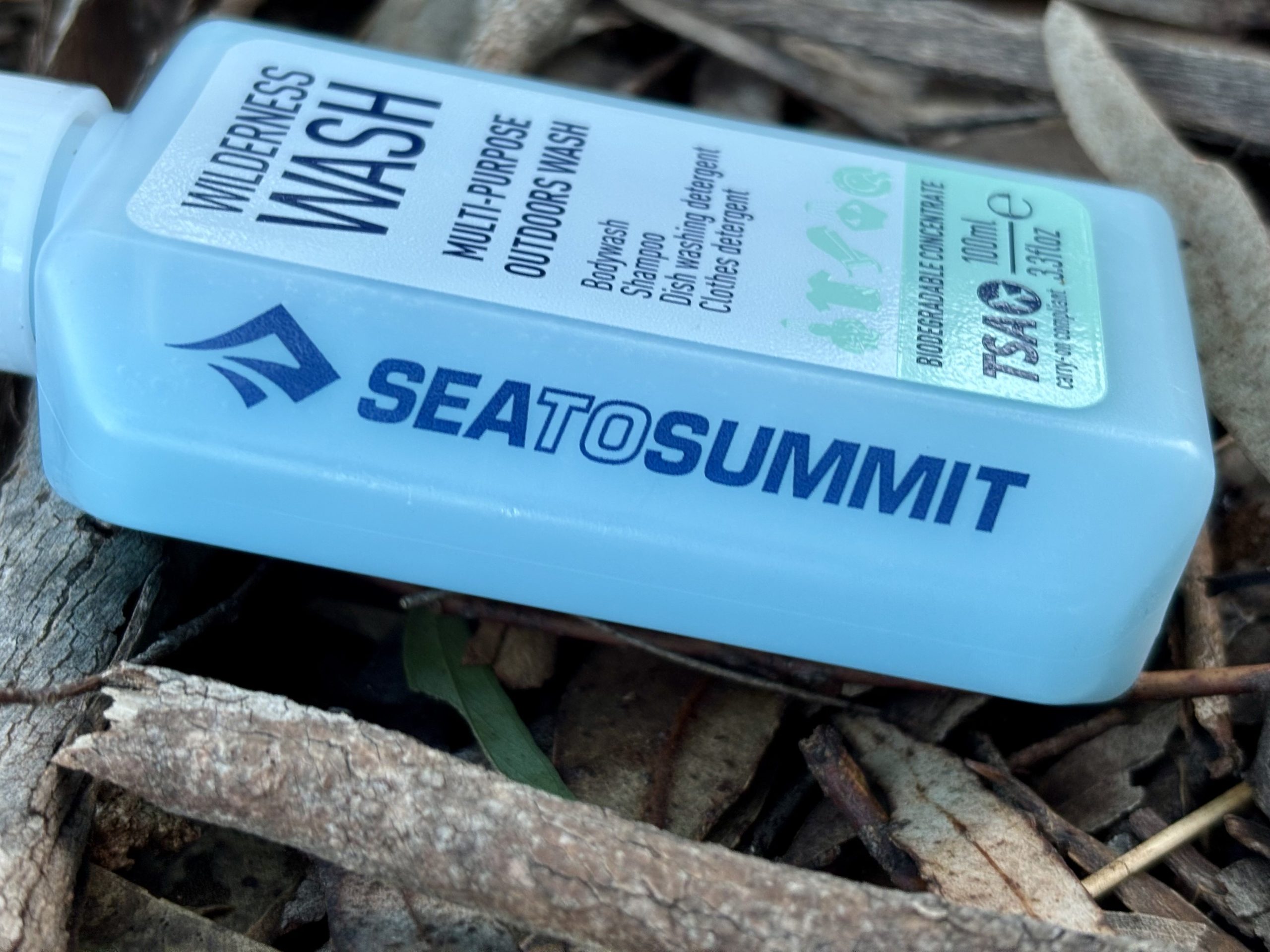 Side view of the Sea to Summit Travel Soap on forest floor