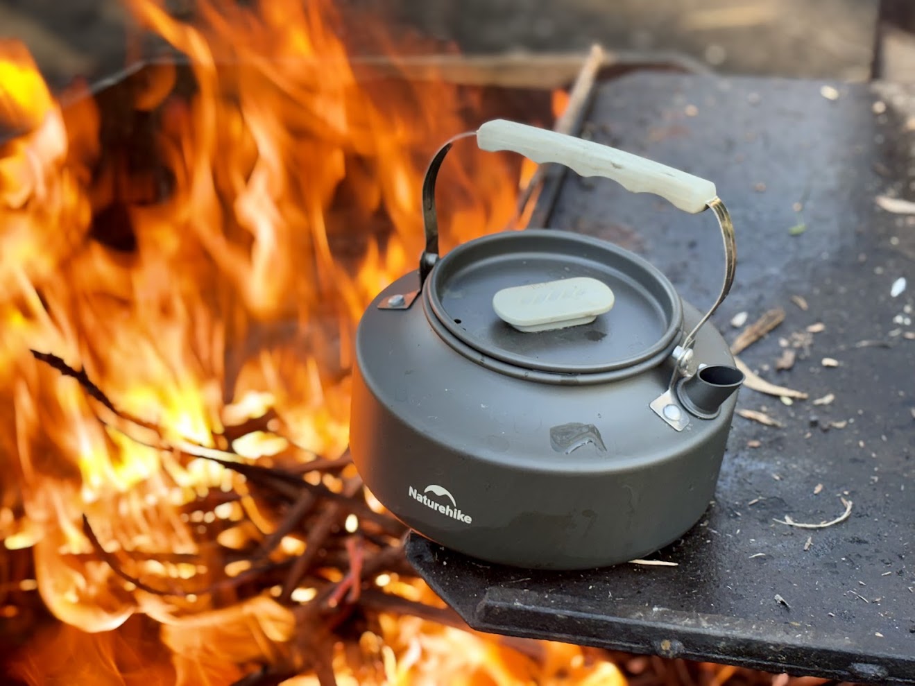 Boiling water over the campfire in the kettle that comes with the Naturehike camping pot set