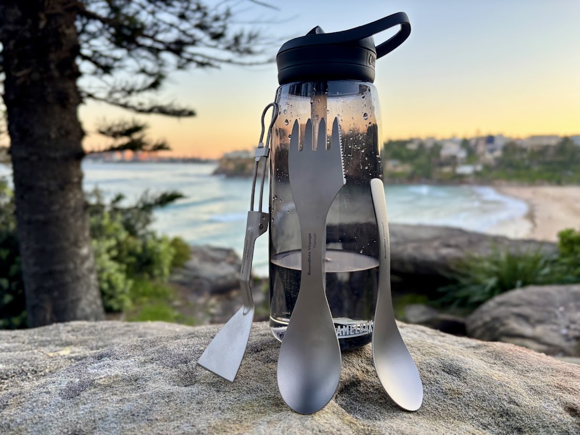 Comparing the size of these Boundless Voyage titanium camp kitchen utensils next to a CamelBak Eddy+ water bottle with a 23.5cm height