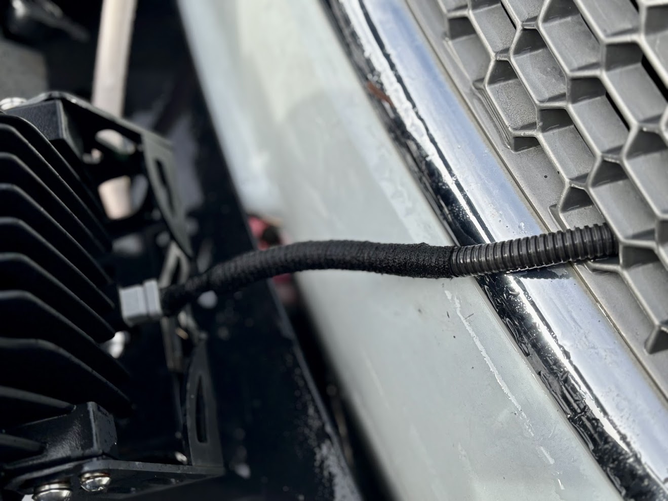 Installing the XTM driving lights onto a bullbar and leading the cabling through the grille for wiring
