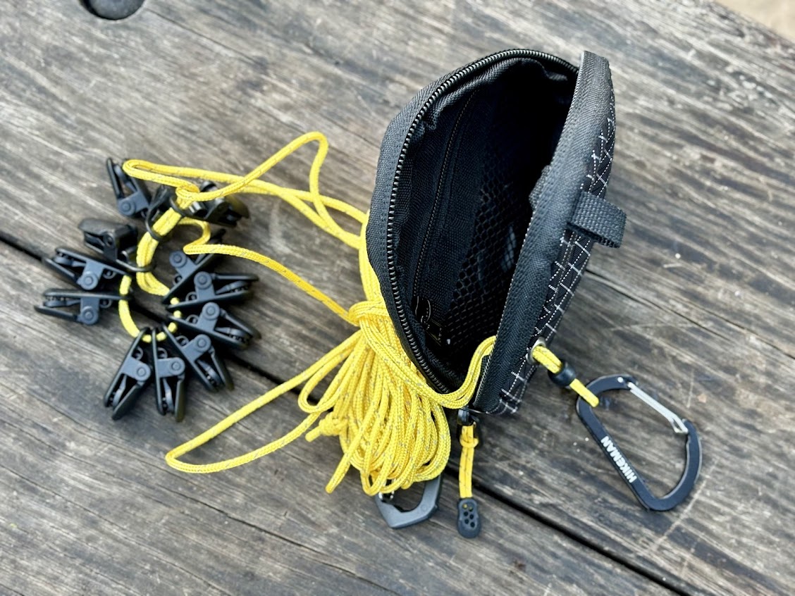 The Hikeman portable camping clothes line​ comes with 12 clips already on the line and an additional 4 clips packed separately in the bag