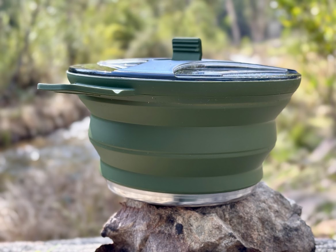 The dark green silicone sides of the collapsible cooking pot are soft, flexible and feel very durable