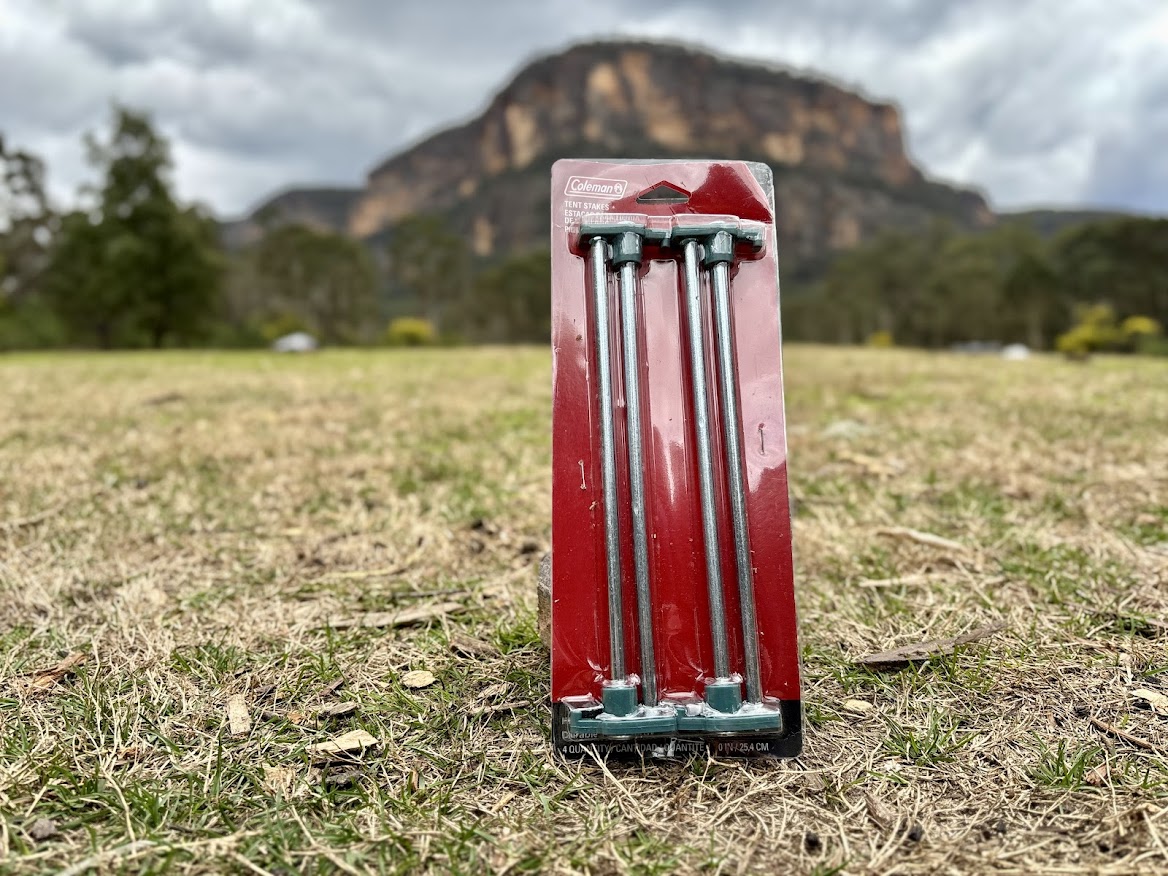 The design of the Coleman 10 inch steel tent stakes is simple, just a thick steel rod with a light green plastic head