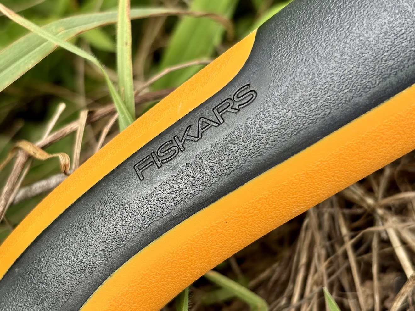The handle of the Fiskars folding saw is made of a hard plastic core with SoftGrip Touchpoints