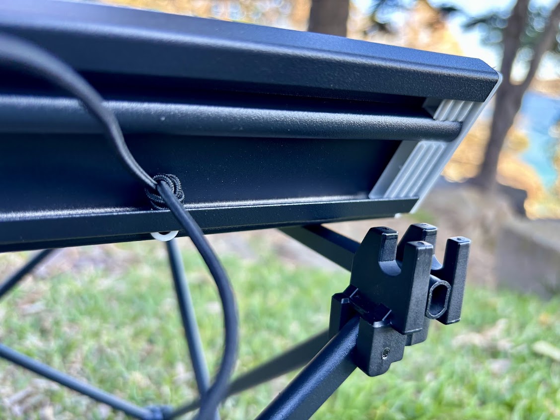 The roll-up table top of the Moon Lence table clips easily onto the triangular frame