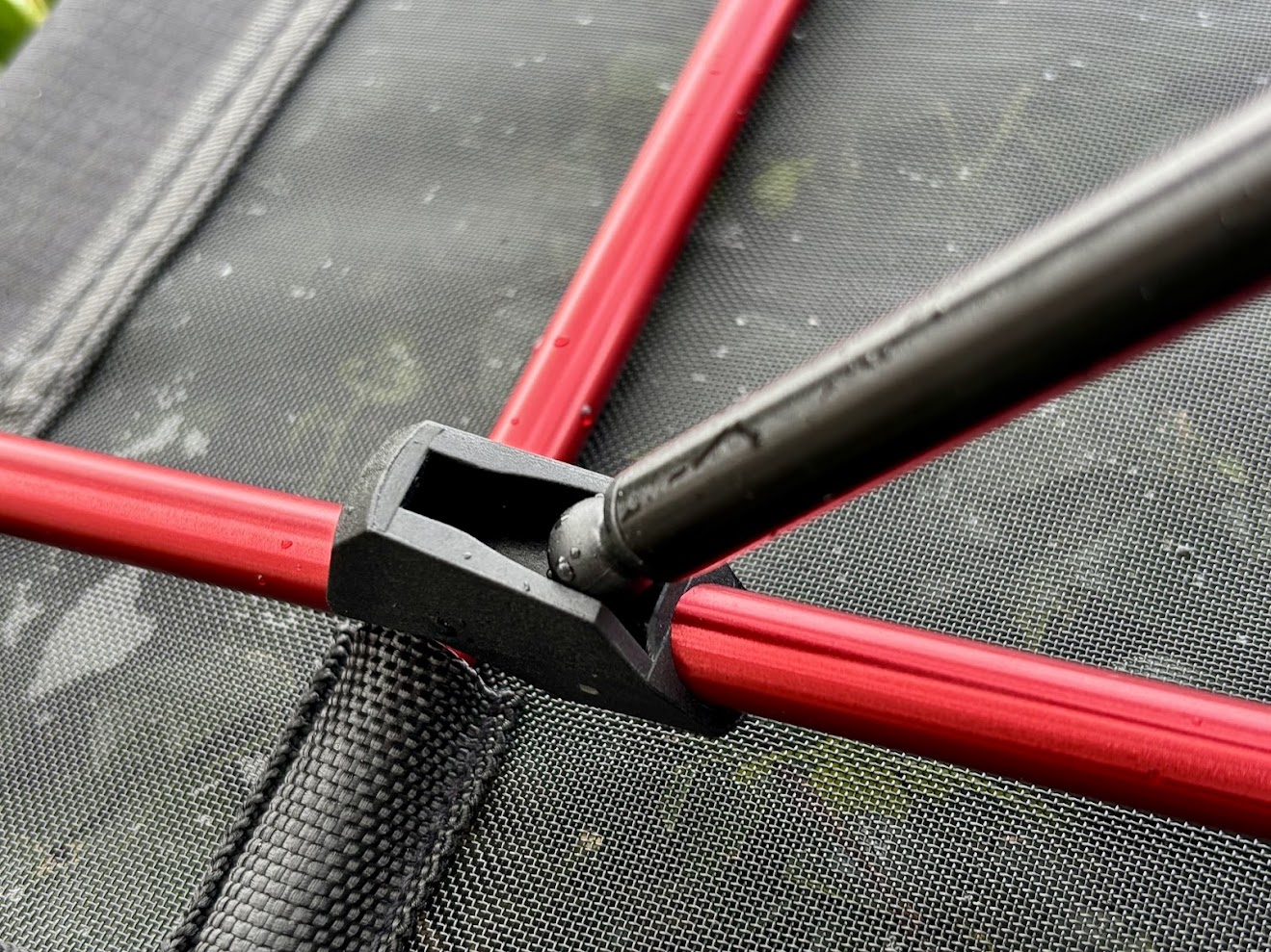 The table top of the Naturehike folding camping table is made from a durable mesh fabric with a reinforcing plastic tube that fits snugly onto the frame