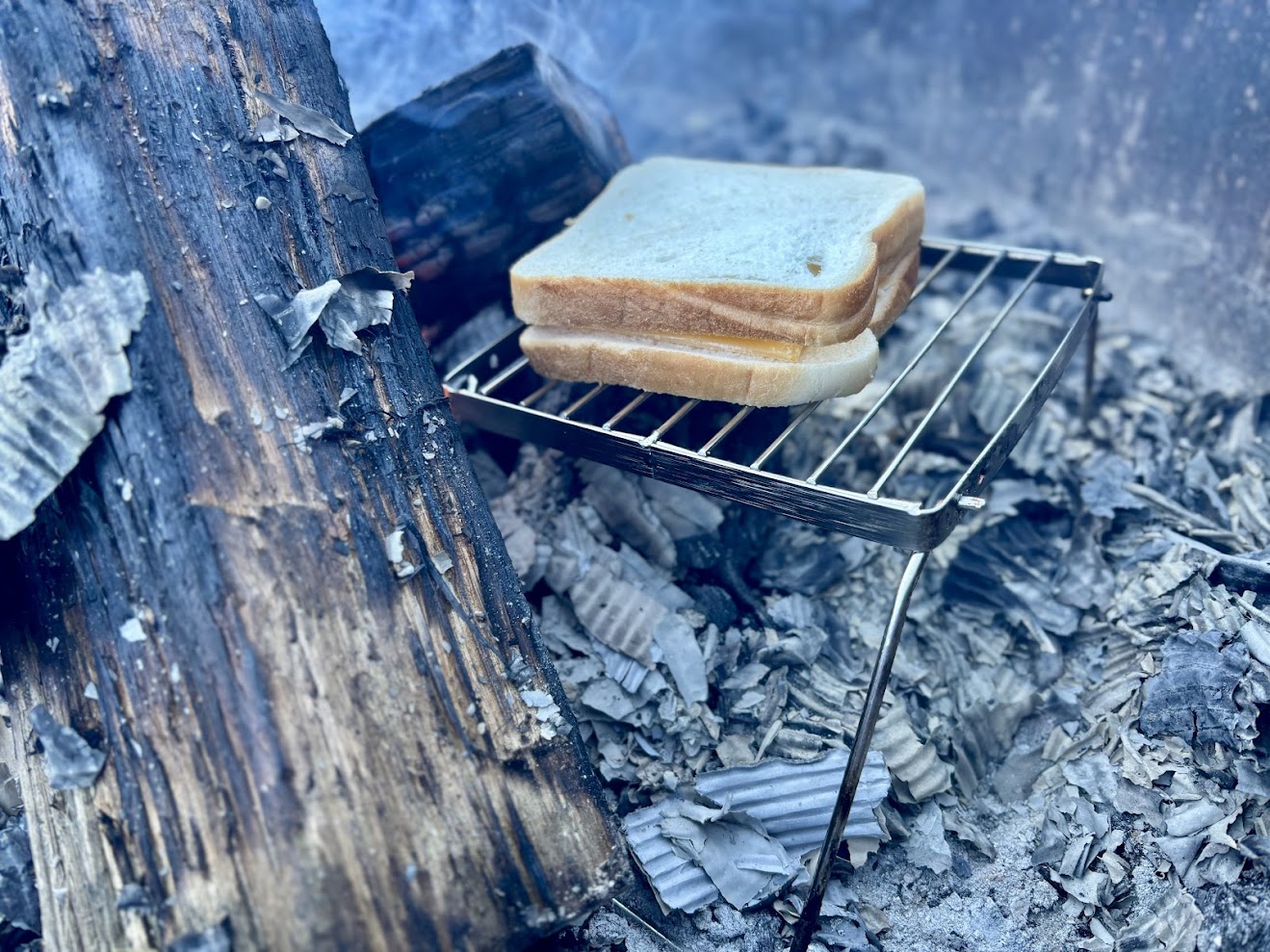 This compact folding campfire grill​ has a cooking surface of 16x16cm which works well for small meals