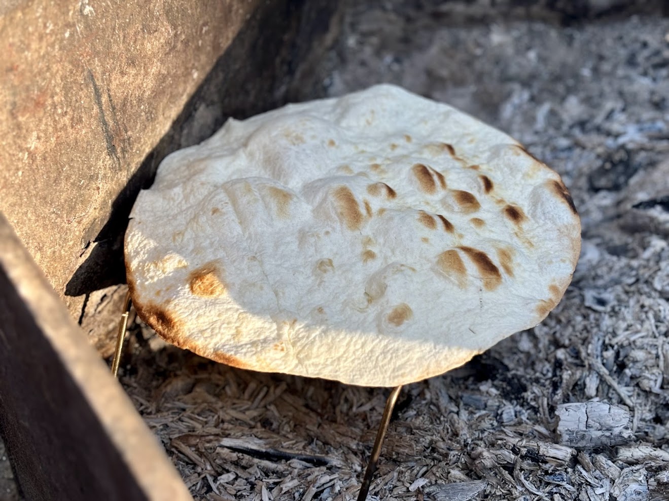 We even use this folding campfire grate to grill tortillas over hot coals