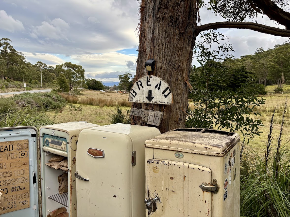 The Bruny Island bread fridge​ is a roadside stop with a small, unpaved parking area directly next to the fridge