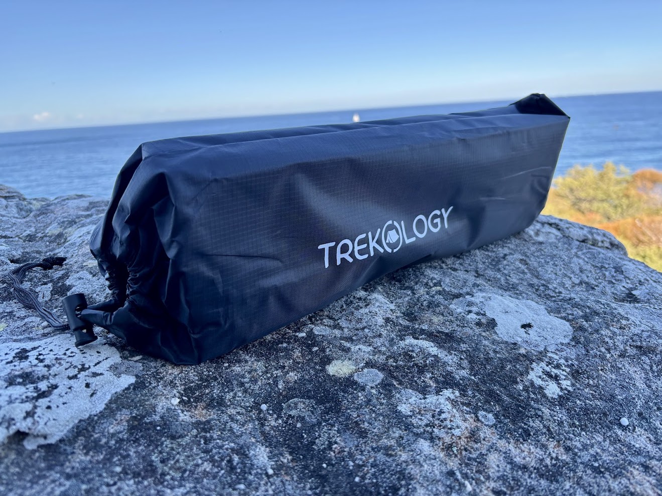 The Trekology portable camping table comes folded into a black carry bag and is incredibly compact
