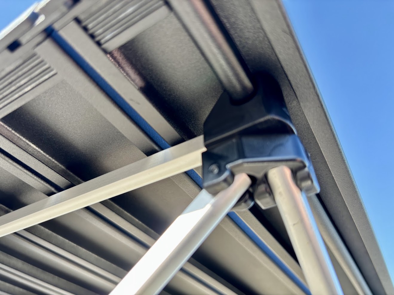 The tabletop on the Trekology portable camping table​ is a set of aluminum slats held together by elastic that snaps onto the base on each corner