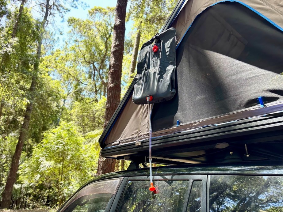 We often use the gas struts on our Rooftop Tent to hang the Adventure Kings camp solar shower high above the ground