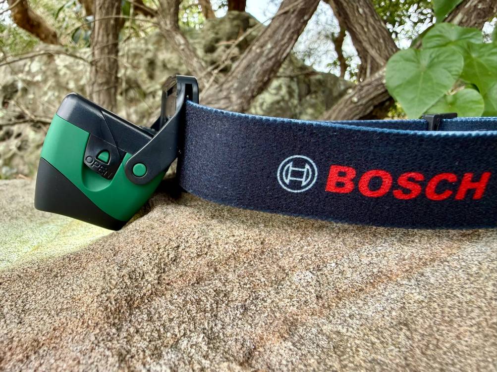 The 60° tilting mechanism on the Bosch headlamp can shift from looking straight ahead on the trail to casting a light directly down