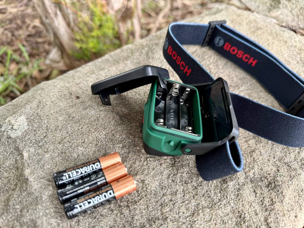 The Bosch headlamp operates on three AAA batteries that are inserted in the body of the head torch